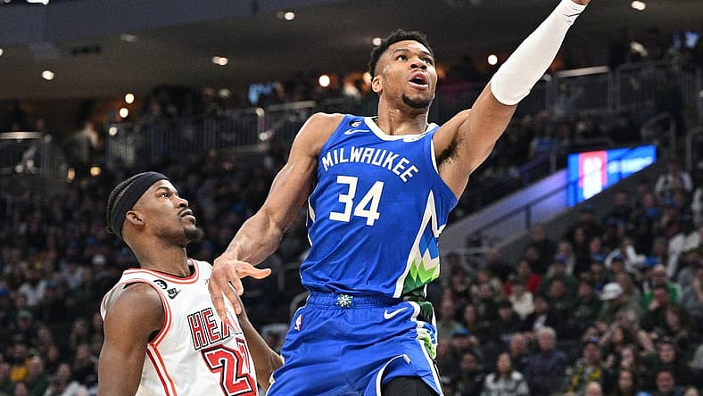 Feb 4, 2023; Milwaukee, Wisconsin, USA; Milwaukee Bucks forward Giannis Antetokounmpo (34) drives to the basket against Miami Heat forward Jimmy Butler (22) in the first half at Fiserv Forum. Mandatory Credit: Michael McLoone-USA TODAY Sports