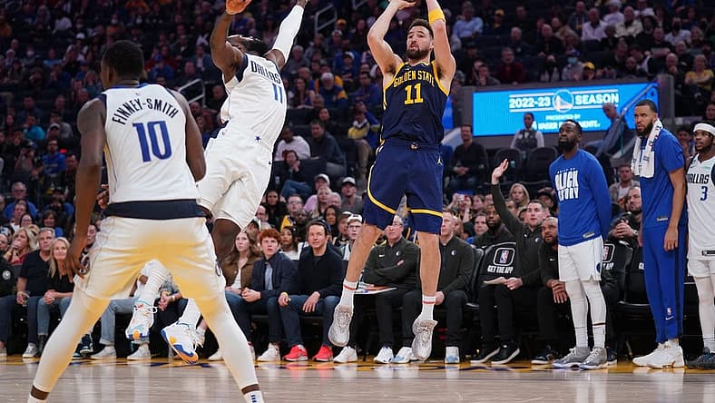 Feb 4, 2023; San Francisco, California, USA; Golden State Warriors guard Klay Thompson (11) shoots the ball over Dallas Mavericks forward Tim Hardaway Jr. (11) in the fourth quarter at the Chase Center. Mandatory Credit: Cary Edmondson-USA TODAY Sports