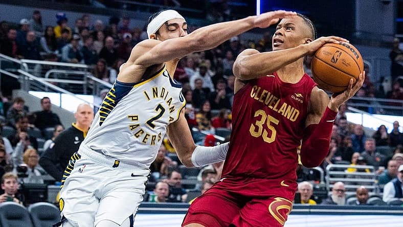 Feb 5, 2023; Indianapolis, Indiana, USA; Cleveland Cavaliers forward Isaac Okoro (35) shoots the ball while Indiana Pacers guard Andrew Nembhard (2)  defends in the second half at Gainbridge Fieldhouse. Mandatory Credit: Trevor Ruszkowski-USA TODAY Sports
