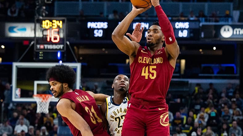 Feb 5, 2023; Indianapolis, Indiana, USA; Cleveland Cavaliers guard Donovan Mitchell (45) shoots the ball while Indiana Pacers forward Aaron Nesmith (23) defends in the second half at Gainbridge Fieldhouse. Mandatory Credit: Trevor Ruszkowski-USA TODAY Sports
