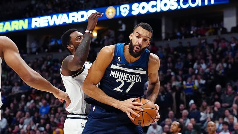 Feb 7, 2023; Denver, Colorado, USA; Minnesota Timberwolves center Rudy Gobert (27) pulls a rebound in away from Denver Nuggets forward Jeff Green (32) in the second quarter at Ball Arena. Mandatory Credit: Ron Chenoy-USA TODAY Sports