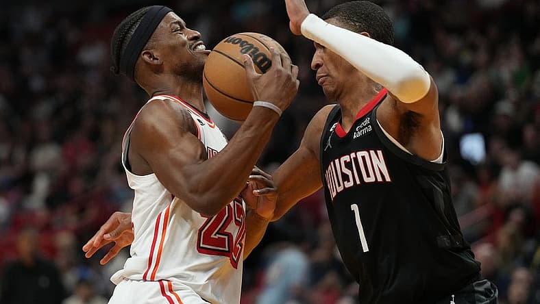 Feb 10, 2023; Miami, Florida, USA; Miami Heat forward Jimmy Butler (22) gets fouled by Houston Rockets forward Jabari Smith Jr. (1) in the first half at Miami-Dade Arena. Mandatory Credit: Jim Rassol-USA TODAY Sports