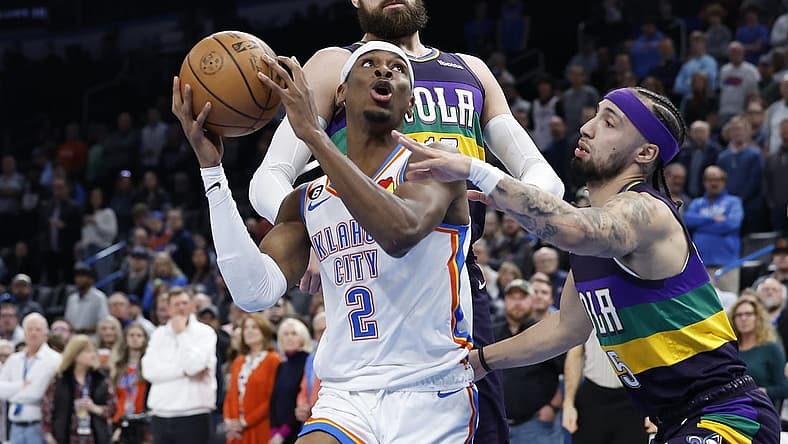 Feb 13, 2023; Oklahoma City, Oklahoma, USA; Oklahoma City Thunder guard Shai Gilgeous-Alexander (2) is defended by New Orleans Pelicans forward Herbert Jones (5) on a drive to the basket during the first quarter at Paycom Center. Mandatory Credit: Alonzo Adams-USA TODAY Sports