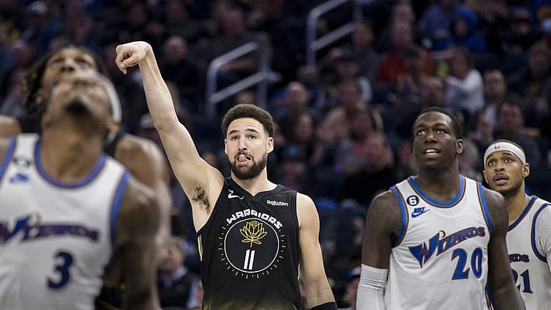 Feb 13, 2023; San Francisco, California, USA; Golden State Warriors guard Klay Thompson (11) watches his shot drop against the Washington Wizards during the first half at Chase Center. Mandatory Credit: John Hefti-USA TODAY Sports