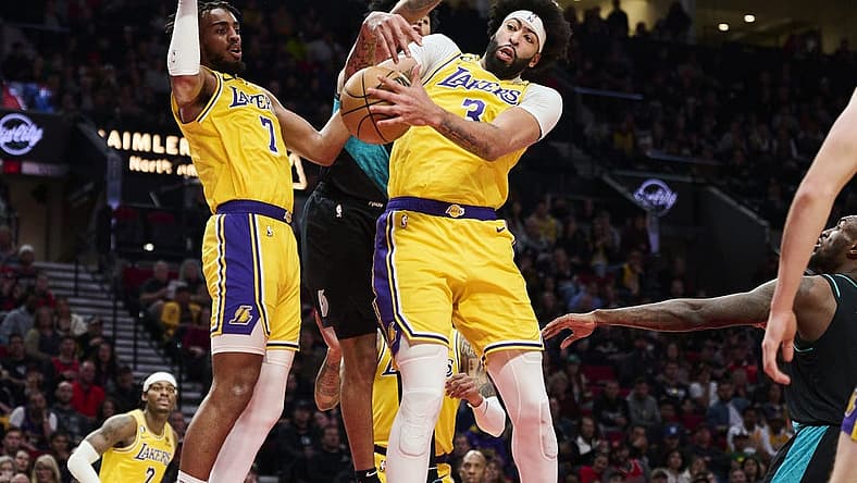 Feb 13, 2023; Portland, Oregon, USA; Los Angeles Lakers forward Anthony Davis (3) grabs a rebound during the second half against Portland Trail Blazers guard Anfernee Simons (1) at Moda Center. Mandatory Credit: Troy Wayrynen-USA TODAY Sports