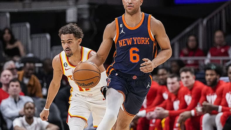 Feb 15, 2023; Atlanta, Georgia, USA; New York Knicks guard Quentin Grimes (6) dribblers past Atlanta Hawks guard Trae Young (11) during the first half at State Farm Arena. Mandatory Credit: Dale Zanine-USA TODAY Sports
