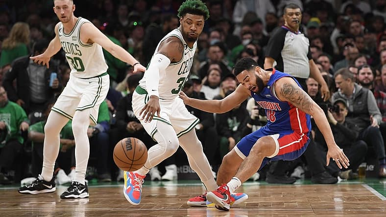 Feb 15, 2023; Boston, Massachusetts, USA; Boston Celtics guard Marcus Smart (36) steals the ball from Detroit Pistons guard Cory Joseph (18) during the first half at TD Garden. Mandatory Credit: Bob DeChiara-USA TODAY Sports