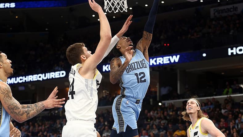 Feb 15, 2023; Memphis, Tennessee, USA; Memphis Grizzlies guard Ja Morant (12) shoots as Utah Jazz center Walker Kessler (24) defends during the first half at FedExForum. Mandatory Credit: Petre Thomas-USA TODAY Sports