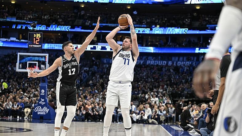Feb 23, 2023; Dallas, Texas, USA; Dallas Mavericks guard Luka Doncic (77) shoots over San Antonio Spurs forward Doug McDermott (17) during the second quarter at the American Airlines Center. Mandatory Credit: Jerome Miron-USA TODAY Sports