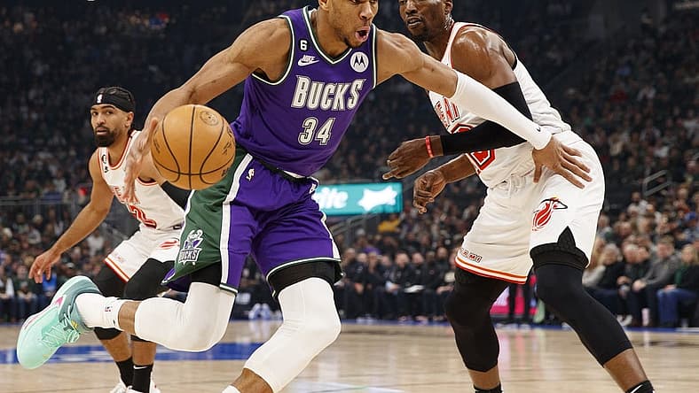 Feb 24, 2023; Milwaukee, Wisconsin, USA;  Milwaukee Bucks forward Giannis Antetokounmpo (34) drives for the basket against Miami Heat center Bam Adebayo (13) during the first quarter at Fiserv Forum. Mandatory Credit: Jeff Hanisch-USA TODAY Sports
