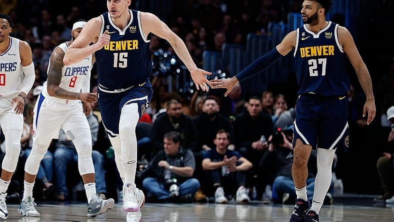 Feb 26, 2023; Denver, Colorado, USA; Denver Nuggets center Nikola Jokic (15) reacts with guard Jamal Murray (27) after a play in the first quarter against the Los Angeles Clippers at Ball Arena. Mandatory Credit: Isaiah J. Downing-USA TODAY Sports