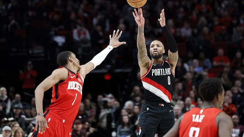 Feb 26, 2023; Portland, Oregon, USA; Portland Trail Blazers point guard Damian Lillard (0) shoots the ball over Houston Rockets power forward Jabari Smith Jr. (1) during the second half at Moda Center. Mandatory Credit: Soobum Im-USA TODAY Sports