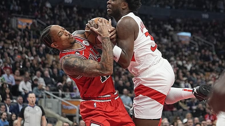 Feb 28, 2023; Toronto, Ontario, CAN; Chicago Bulls forward DeMar DeRozan (11) and Toronto Raptors forward O.G. Anunoby (3) battle for the ball during the first half at Scotiabank Arena. Mandatory Credit: John E. Sokolowski-USA TODAY Sports