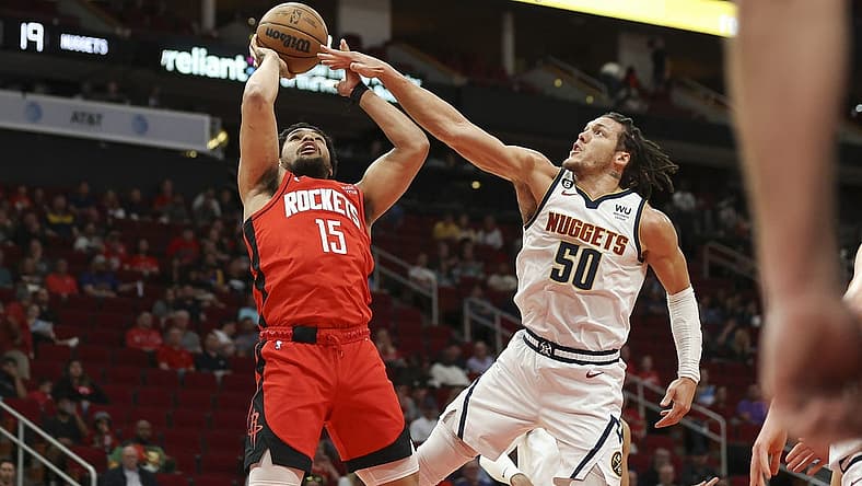 Feb 28, 2023; Houston, Texas, USA; Houston Rockets guard Daishen Nix (15) shoots the ball as Denver Nuggets forward Aaron Gordon (50) defends during the first quarter at Toyota Center. Mandatory Credit: Troy Taormina-USA TODAY Sports