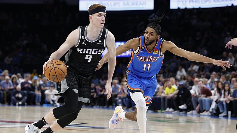 Feb 28, 2023; Oklahoma City, Oklahoma, USA; Sacramento Kings guard Kevin Huerter (9) drives to the basket around Oklahoma City Thunder guard Isaiah Joe (11) during the first quarter at Paycom Center. Mandatory Credit: Alonzo Adams-USA TODAY Sports