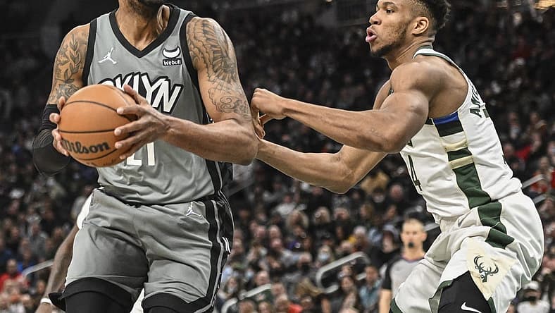 Feb 26, 2022; Milwaukee, Wisconsin, USA; Brooklyn Nets center LaMarcus Aldridge (21) controls the ball against Milwaukee Bucks forward Giannis Antetokounmpo (34) in the fourth quarter at Fiserv Forum. Mandatory Credit: Benny Sieu-USA TODAY Sports
