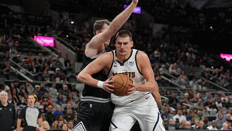 Nov 7, 2022; San Antonio, Texas, USA;  Denver Nuggets center Nikola Jokic (15) drives in against San Antonio Spurs center Jakob Poeltl (25) in the second half at the AT&T Center. Mandatory Credit: Daniel Dunn-USA TODAY Sports