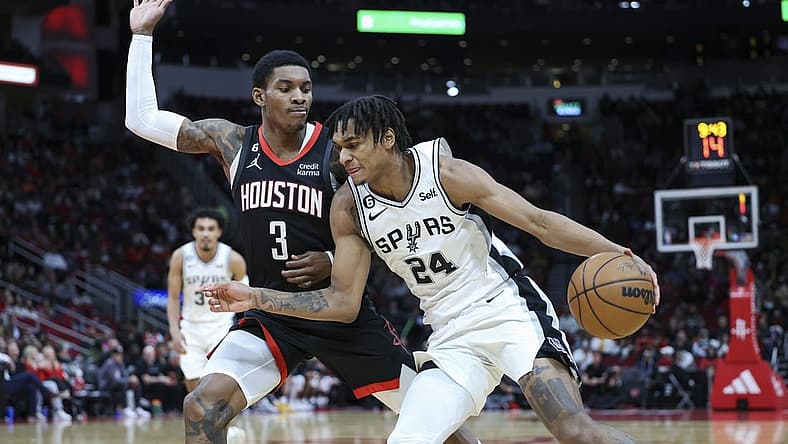 Dec 19, 2022; Houston, Texas, USA; San Antonio Spurs guard Devin Vassell (24) attempts to dribble the ball around Houston Rockets guard Kevin Porter Jr. (3) during the third quarter at Toyota Center. Mandatory Credit: Troy Taormina-USA TODAY Sports