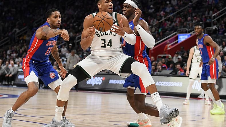 Jan 23, 2023; Detroit, Michigan, USA; Milwaukee Bucks forward Giannis Antetokounmpo's (34) drives to the basket against Detroit Pistons guard Rodney McGruder (17) (left) and center Jalen Duran (0) in the third quarter at Little Caesars Arena. Mandatory Credit: Lon Horwedel-USA TODAY Sports