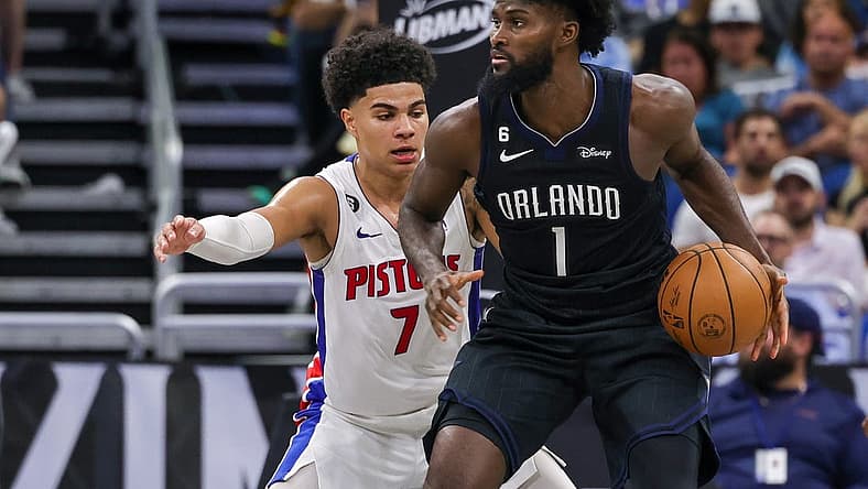 Feb 23, 2023; Orlando, Florida, USA; Detroit Pistons guard Killian Hayes (7) defends Orlando Magic forward Jonathan Isaac (1) during the second half at Amway Center. Mandatory Credit: Mike Watters-USA TODAY Sports
