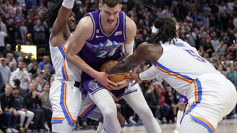 Feb 23, 2023; Salt Lake City, Utah, USA; Utah Jazz center Walker Kessler (24) is fouled by Oklahoma City Thunder guard Luguentz Dort (5) during the second half at Vivint Arena. Mandatory Credit: Chris Nicoll-USA TODAY Sports