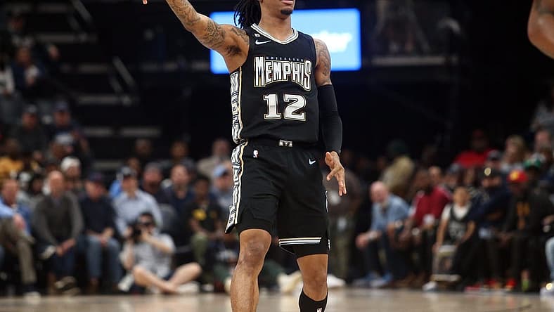 Feb 28, 2023; Memphis, Tennessee, USA; Memphis Grizzlies guard Ja Morant (12) reacts after shooting for three during the first half against the Los Angeles Lakers at FedExForum. Mandatory Credit: Petre Thomas-USA TODAY Sports