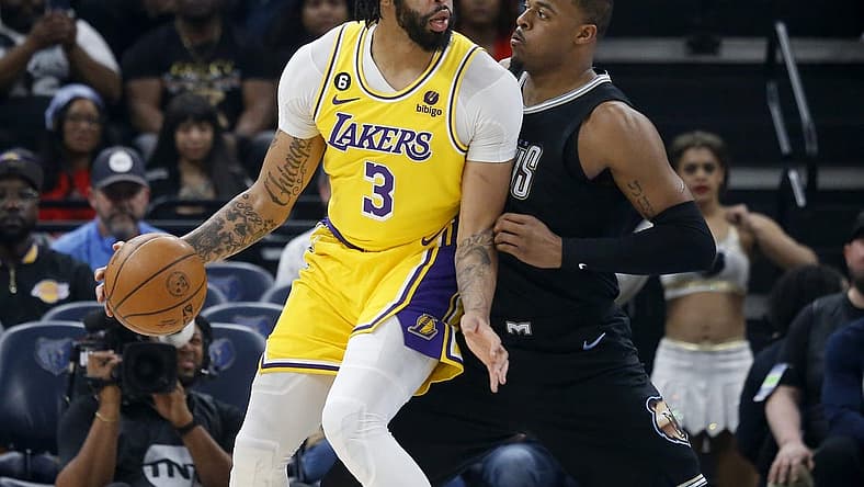 Feb 28, 2023; Memphis, Tennessee, USA; Los Angeles Lakers forward Anthony Davis (3) handles the ball as Memphis Grizzlies forward Xavier Tillman (2) defends during the first half at FedExForum. Mandatory Credit: Petre Thomas-USA TODAY Sports