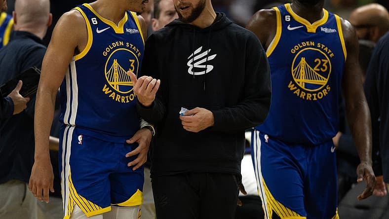 Feb 28, 2023; San Francisco, California, USA; Golden State Warriors guard Jordan Poole (3) confers with injured teammate Stephen Curry during a timeout in the fourth quarter against the Portland Trail Blazers at Chase Center. Mandatory Credit: D. Ross Cameron-USA TODAY Sports