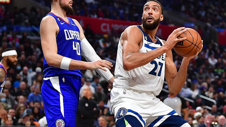 Feb 28, 2023; Los Angeles, California, USA; Minnesota Timberwolves center Rudy Gobert (27) moves to the basket against Los Angeles Clippers center Ivica Zubac (40) during the second half at Crypto.com Arena. Mandatory Credit: Gary A. Vasquez-USA TODAY Sports