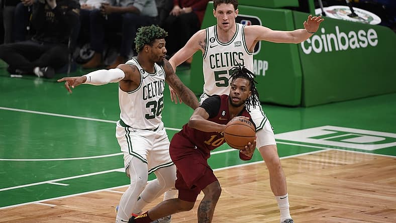 Mar 1, 2023; Boston, Massachusetts, USA; Cleveland Cavaliers guard Darius Garland (10) controls the ball while Boston Celtics guard Marcus Smart (36) and forward Mike Mascala (57) defend during the first half at TD Garden. Mandatory Credit: Bob DeChiara-USA TODAY Sports