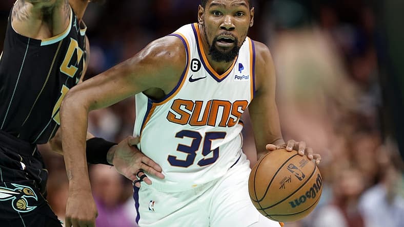 Mar 1, 2023; Charlotte, North Carolina, USA; Phoenix Suns forward Kevin Durant (35) drives to the basket past Charlotte Hornets guard Kelly Oubre Jr. (12) during the second half at Spectrum Center. Mandatory Credit: Brian Westerholt-USA TODAY Sports