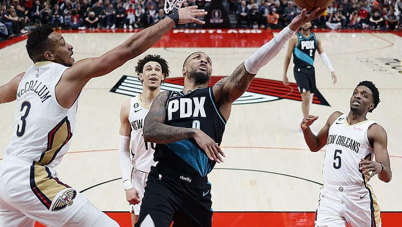Mar 1, 2023; Portland, Oregon, USA; Portland Trail Blazers point guard Damian Lillard (0) shoots the ball against New Orleans Pelicans shooting guard CJ McCollum (3) during the first half at Moda Center. Mandatory Credit: Soobum Im-USA TODAY Sports