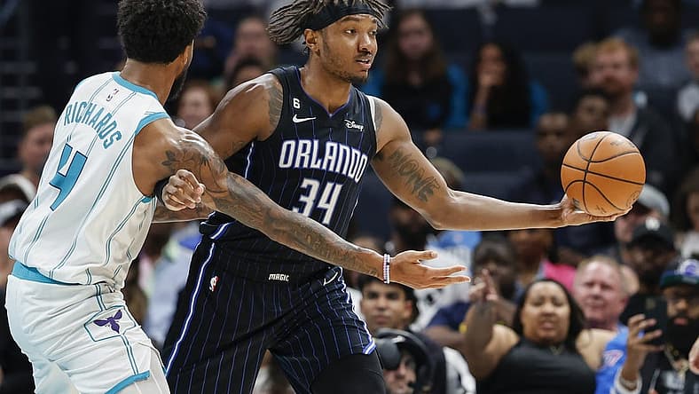 Mar 3, 2023; Charlotte, North Carolina, USA; Orlando Magic center Wendell Carter Jr. (34) looks to pass against Charlotte Hornets center Nick Richards (4) during the second half at Spectrum Center. Mandatory Credit: Nell Redmond-USA TODAY Sports