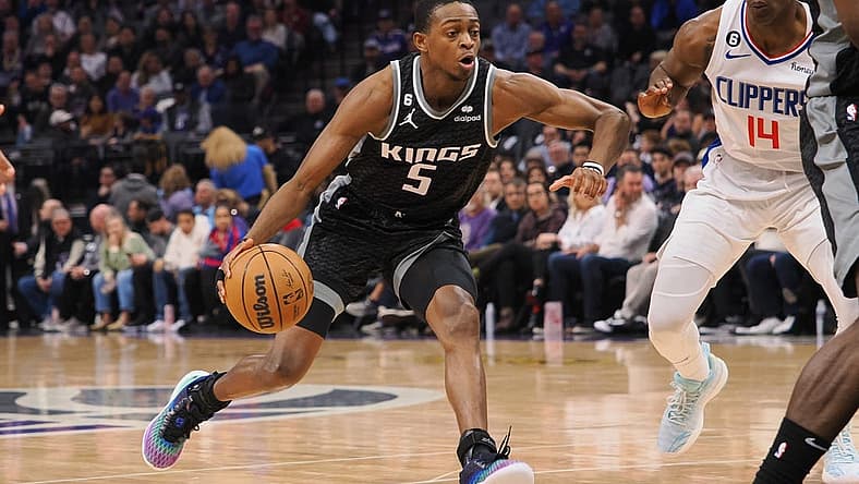 Mar 3, 2023; Sacramento, California, USA; Sacramento Kings point guard De'Aaron Fox (5) drives in against Los Angeles Clippers shooting guard Terance Mann (14) during the second quarter at Golden 1 Center. Mandatory Credit: Kelley L Cox-USA TODAY Sports