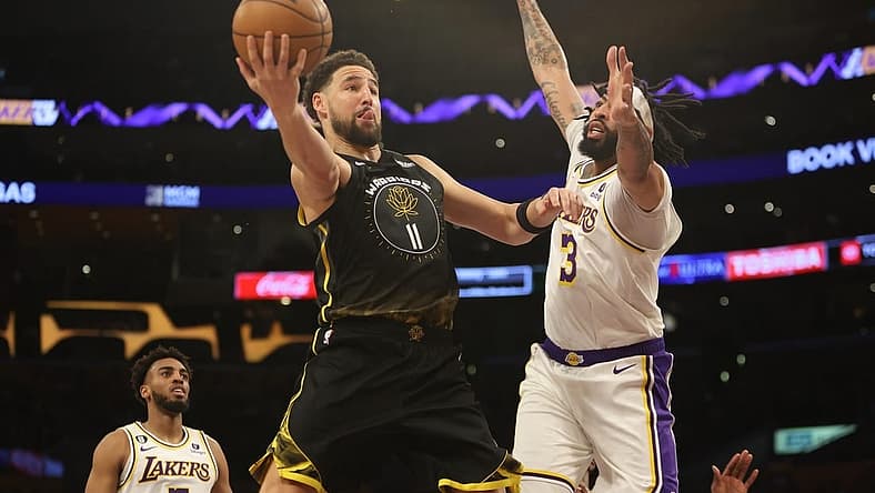 Mar 5, 2023; Los Angeles, California, USA; Golden State Warriors guard Klay Thompson (11) goes to the basket against Los Angeles Lakers forward Anthony Davis (3) during the first quarter at Crypto.com Arena. Mandatory Credit: Kiyoshi Mio-USA TODAY Sports