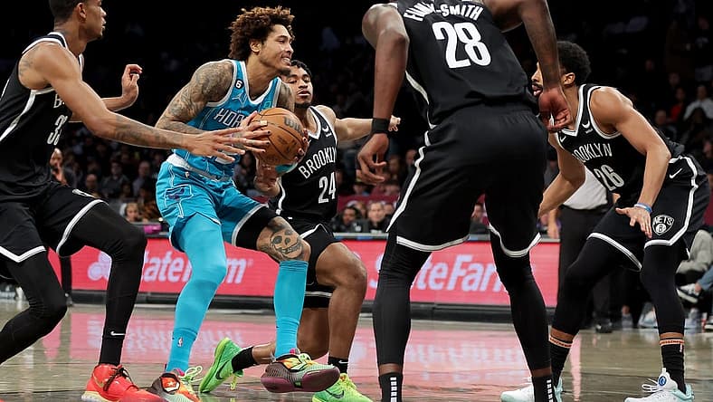 Mar 5, 2023; Brooklyn, New York, USA; Charlotte Hornets guard Kelly Oubre Jr. (12) drives to the basket against Brooklyn Nets center Nic Claxton (33) and guard Cam Thomas (24) and forward Dorian Finney-Smith (28) and guard Spencer Dinwiddie (26) during the second quarter at Barclays Center. Mandatory Credit: Brad Penner-USA TODAY Sports