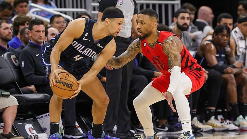 Mar 5, 2023; Orlando, Florida, USA; Portland Trail Blazers guard Damian Lillard (0) defends Orlando Magic guard Jalen Suggs (4) during the second quarter at Amway Center. Mandatory Credit: Mike Watters-USA TODAY Sports