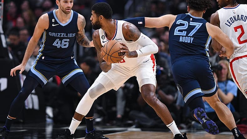 Mar 5, 2023; Los Angeles, California, USA; LA Clippers forward Paul George (13) looks to pass the ball against Memphis Grizzlies guard John Konchar (46) and forward David Roddy (27) during second quarter at Crypto.com Arena. Mandatory Credit: Jonathan Hui-USA TODAY Sports