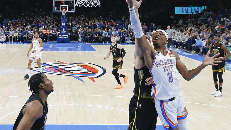 Mar 7, 2023; Oklahoma City, Oklahoma, USA; Oklahoma City Thunder guard Shai Gilgeous-Alexander (2) goes to the basket in front of Golden State Warriors guard Klay Thompson (11) during the first half at Paycom Center. Oklahoma City won 137-128. Mandatory Credit: Alonzo Adams-USA TODAY Sports