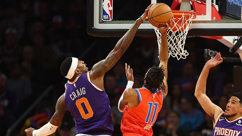 Mar 8, 2023; Phoenix, Arizona, USA; Phoenix Suns forward Torrey Craig (0) blocks the shot of Oklahoma City Thunder guard Isaiah Joe (11) in the first half at Footprint Center. Mandatory Credit: Mark J. Rebilas-USA TODAY Sports