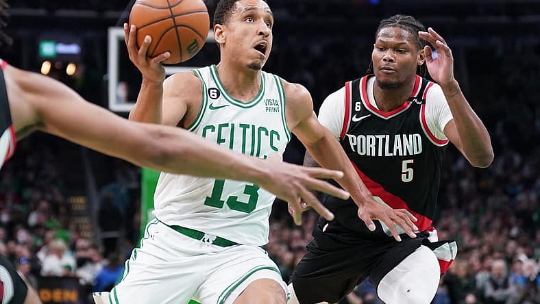 Mar 8, 2023; Boston, Massachusetts, USA; Boston Celtics guard Malcolm Brogdon (13) drives the ball against Portland Trail Blazers forward Cam Reddish (5) in the second half at TD Garden. Mandatory Credit: David Butler II-USA TODAY Sports