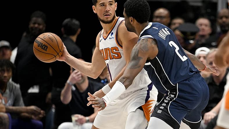 Mar 5, 2023; Dallas, Texas, USA; Phoenix Suns guard Devin Booker (1) and Dallas Mavericks guard Kyrie Irving (2) in action during the game between the Dallas Mavericks and the Phoenix Suns at the American Airlines Center. Mandatory Credit: Jerome Miron-USA TODAY Sports