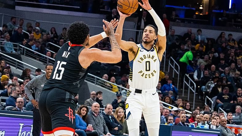 Mar 9, 2023; Indianapolis, Indiana, USA; Indiana Pacers guard Tyrese Haliburton (0) shoots the ball while Houston Rockets guard Daishen Nix (15) defends in the second quarter at Gainbridge Fieldhouse. Mandatory Credit: Trevor Ruszkowski-USA TODAY Sports