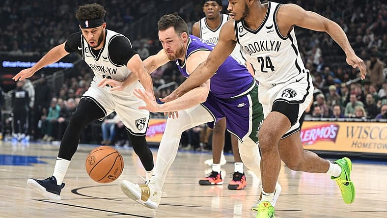 Mar 9, 2023; Milwaukee, Wisconsin, USA; Brooklyn Nets guards Seth Curry (30), left, and Cam Thomas (24) battle for the ball with Milwaukee Bucks guard Pat Connaughton (24) in the first half at Fiserv Forum. Mandatory Credit: Michael McLoone-USA TODAY Sports