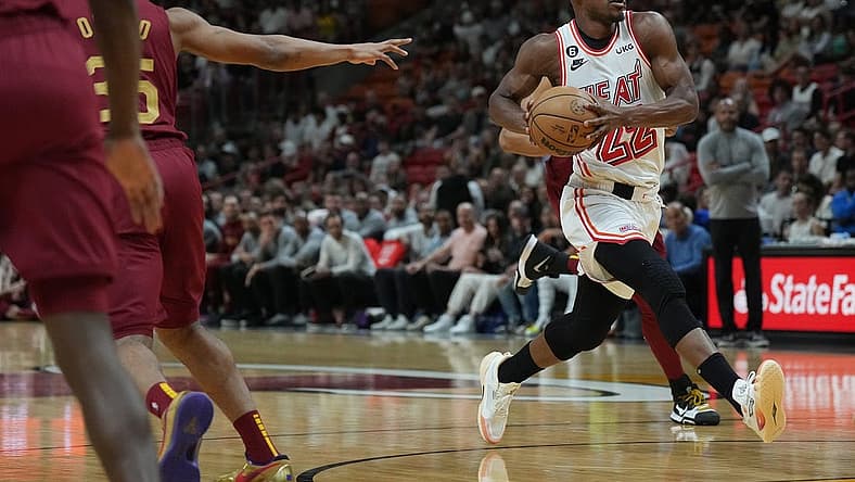 Mar 10, 2023; Miami, Florida, USA;  Miami Heat forward Jimmy Butler (22) heads toward the basket as Cleveland Cavaliers forward Isaac Okoro (35) defends in the first half at Miami-Dade Arena. Mandatory Credit: Jim Rassol-USA TODAY Sports