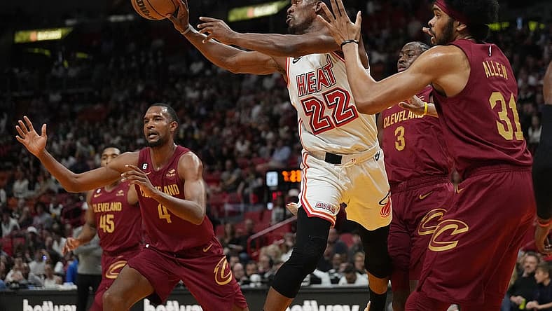Mar 10, 2023; Miami, Florida, USA;  Miami Heat forward Jimmy Butler (22) passes the ball as Cleveland Cavaliers center Jarrett Allen (31) defends during the first half at Miami-Dade Arena. Mandatory Credit: Jim Rassol-USA TODAY Sports