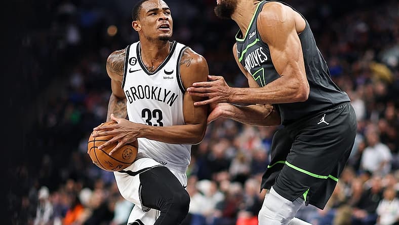 Mar 10, 2023; Minneapolis, Minnesota, USA; Brooklyn Nets center Nic Claxton (33) drives while Minnesota Timberwolves center Rudy Gobert (27) defends during the second quarter at Target Center. Mandatory Credit: Matt Krohn-USA TODAY Sports