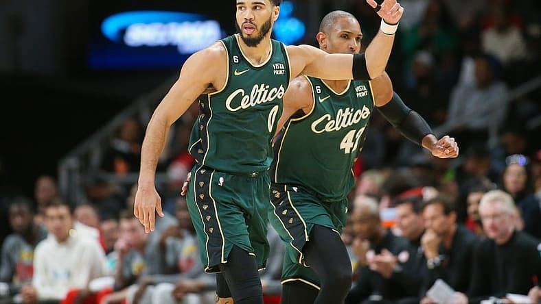 Mar 11, 2023; Atlanta, Georgia, USA; Boston Celtics forward Jayson Tatum (0) reacts after a three-pointer as center Al Horford (42) looks on against the Atlanta Hawks in the second half at State Farm Arena. Mandatory Credit: Brett Davis-USA TODAY Sports