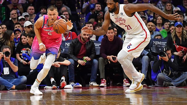 Mar 12, 2023; Philadelphia, Pennsylvania, USA; Washington Wizards center Kristaps Porzingis (6) and Philadelphia 76ers center Joel Embiid (21) chase after loose ball during the first quarter at Wells Fargo Center. Mandatory Credit: Eric Hartline-USA TODAY Sports