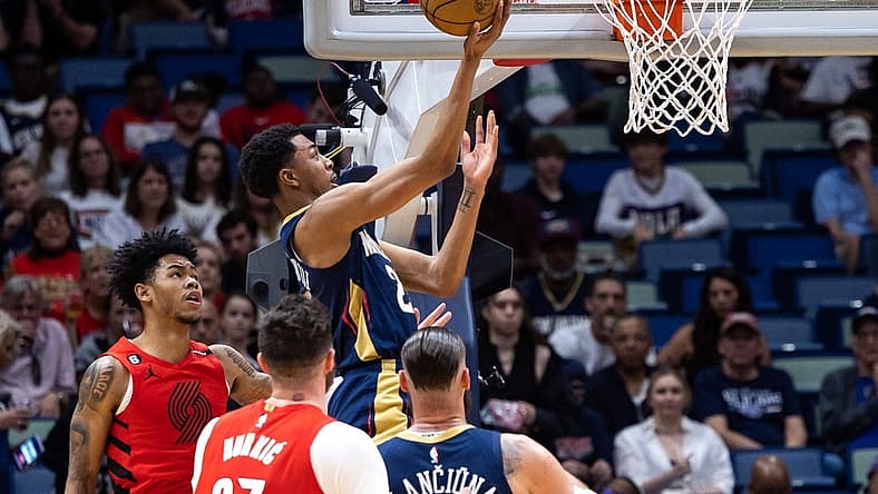 Mar 12, 2023; New Orleans, Louisiana, USA; New Orleans Pelicans guard Trey Murphy III (25) drives to the basket against Portland Trail Blazers center Jusuf Nurkic (27) during the first half at Smoothie King Center. Mandatory Credit: Stephen Lew-USA TODAY Sports